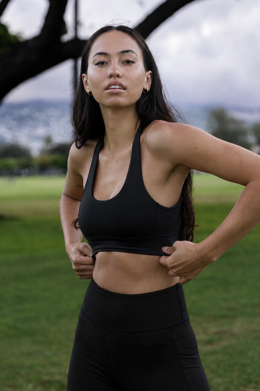 Model wearing a black natural fibre activewear set performance top and leggings