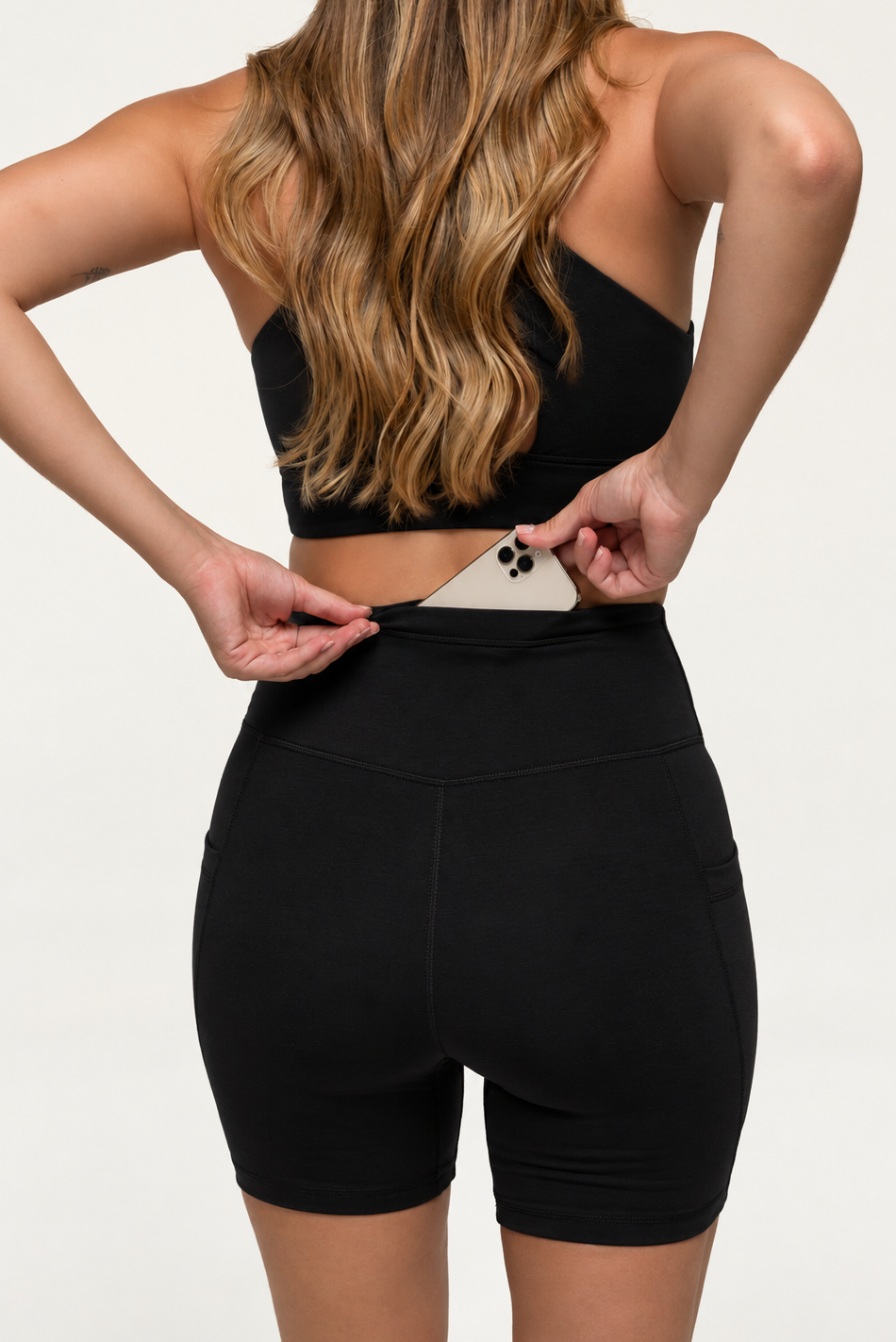 Model wearing black see through natural fibre shorts in black with a back pocket
